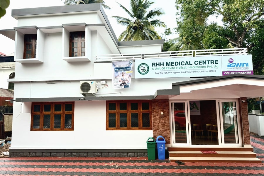 RHH Medical Centre from the road: a white two-storey building on Mini Bypass Road, Thiruvanoor, with the centre&rsquo;s signboard above the entrance.